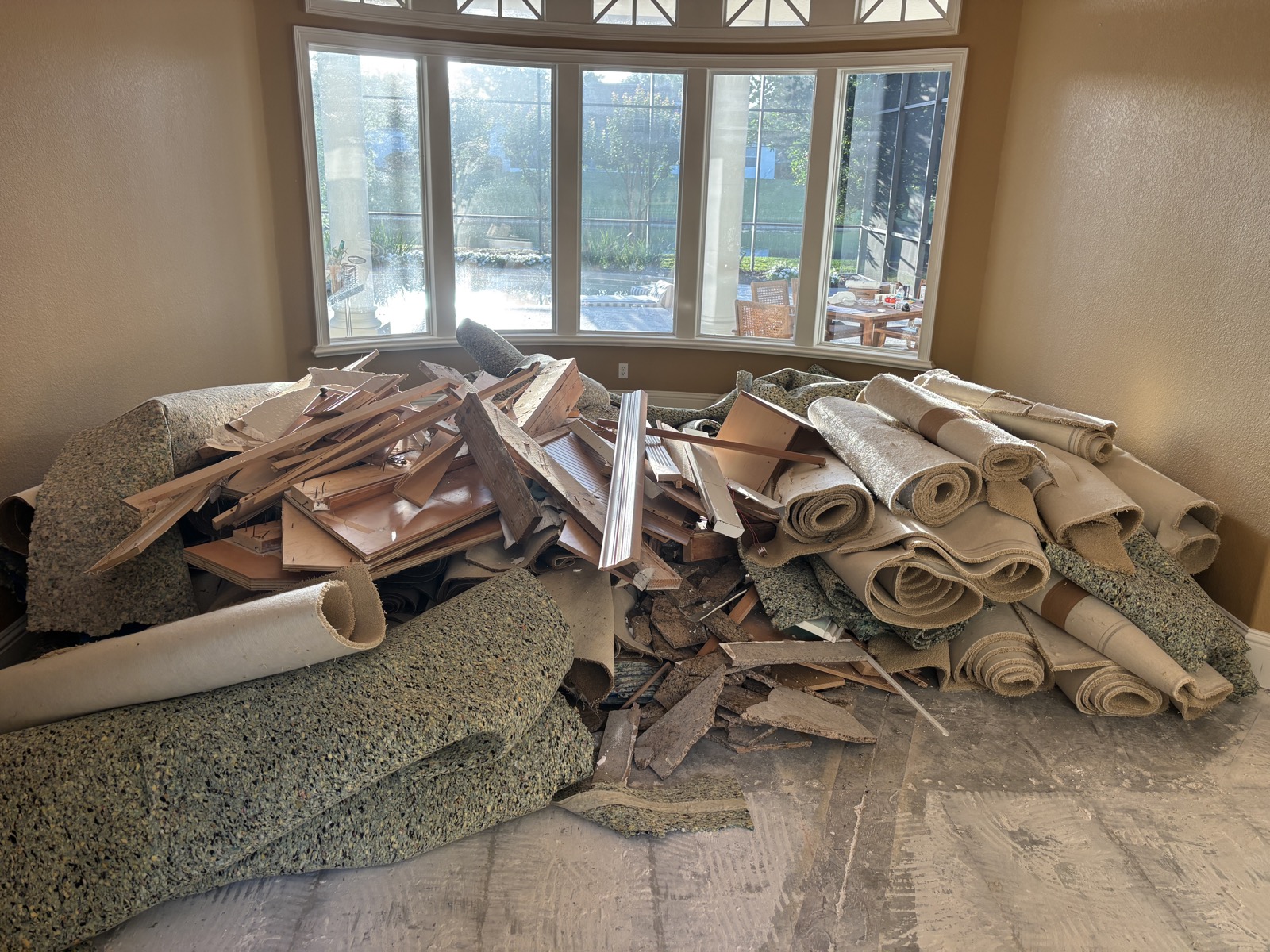 Rolled carpet and renovation debris ready for removal