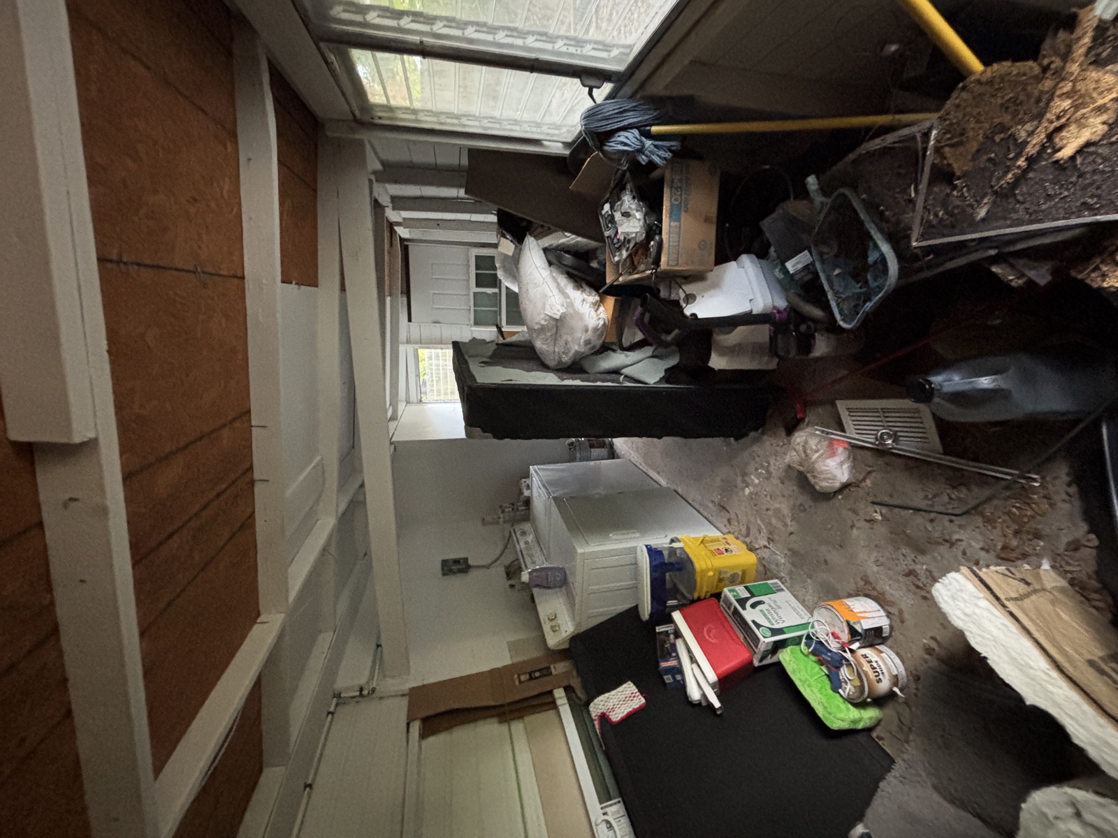 Garage cluttered with junk and old items
