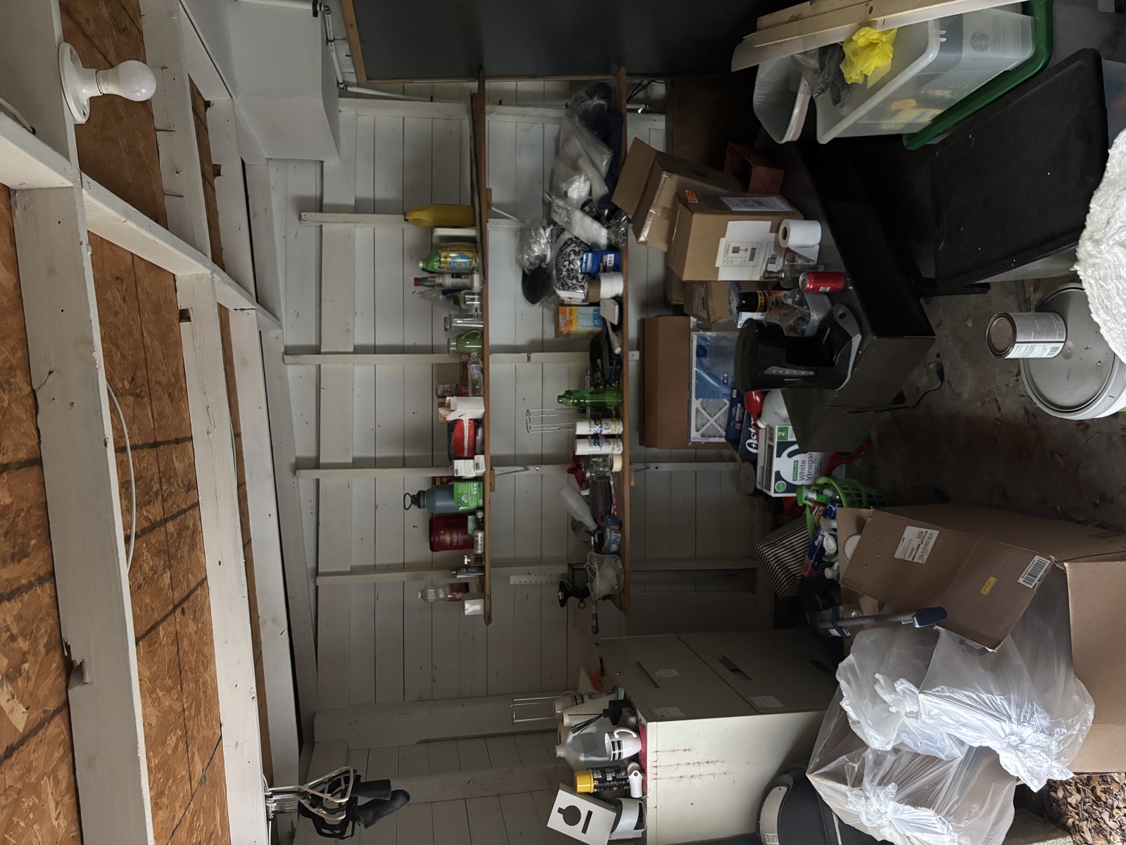 Cluttered shed interior before cleanout