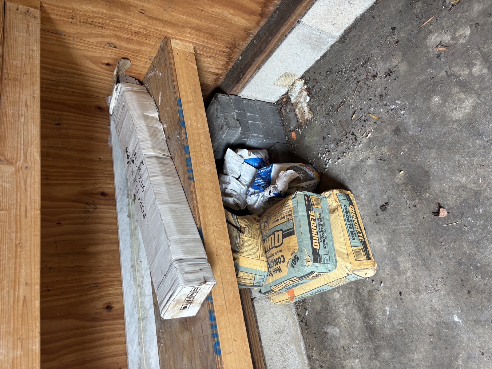 Garage corner with construction materials for removal