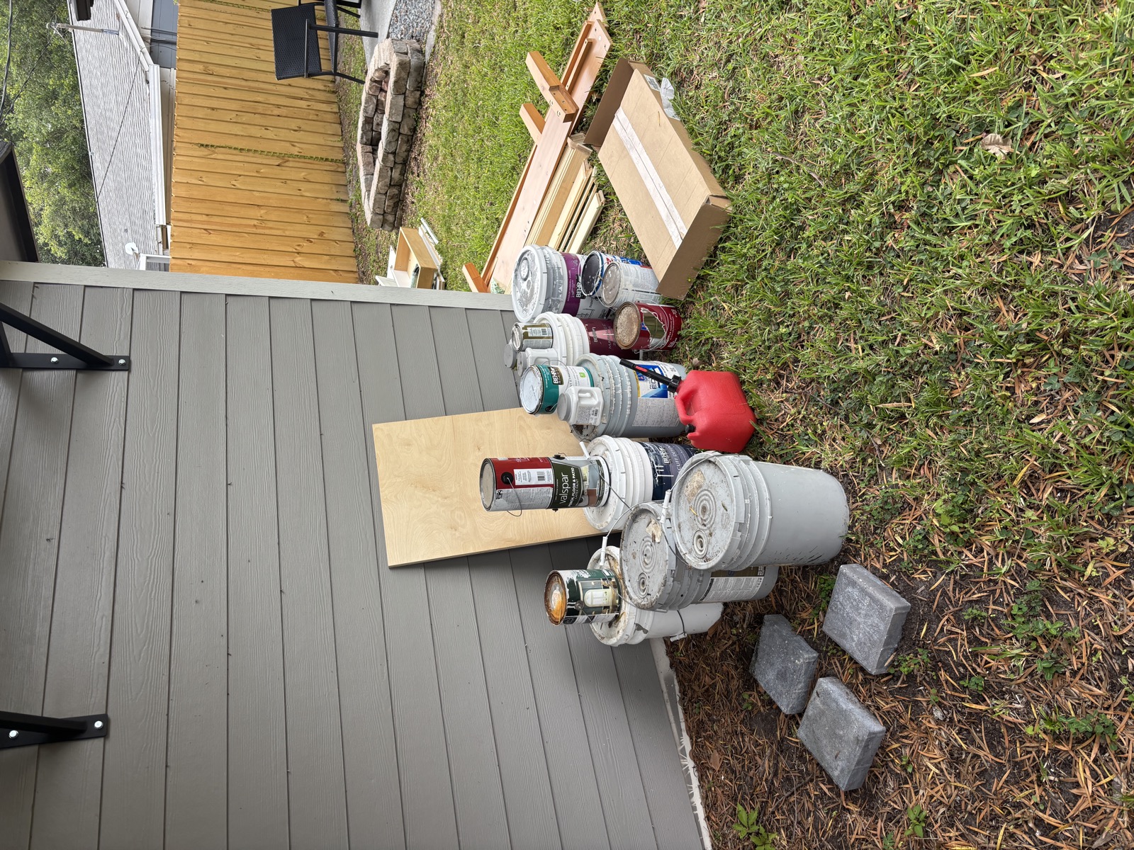 Paint cans and deck debris ready for junk removal